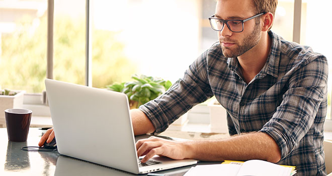 Man learning at home on laptop