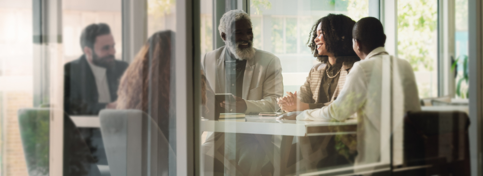 Team working together happily in a business meeting