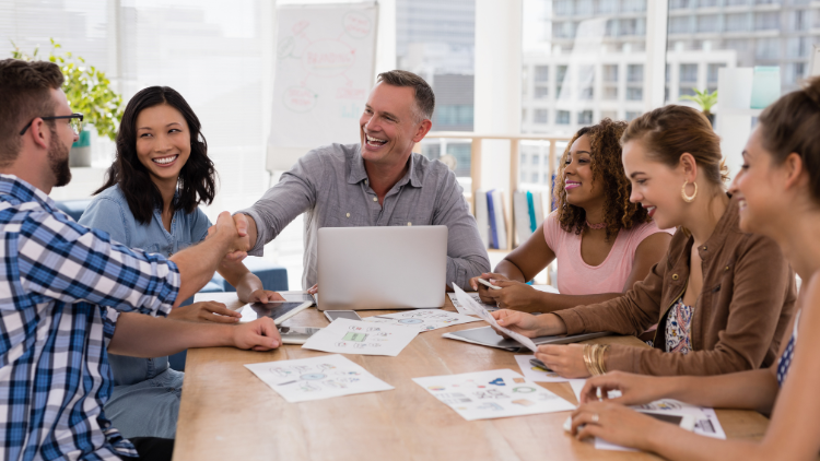 Team meeting in a bright office, employees looking happy